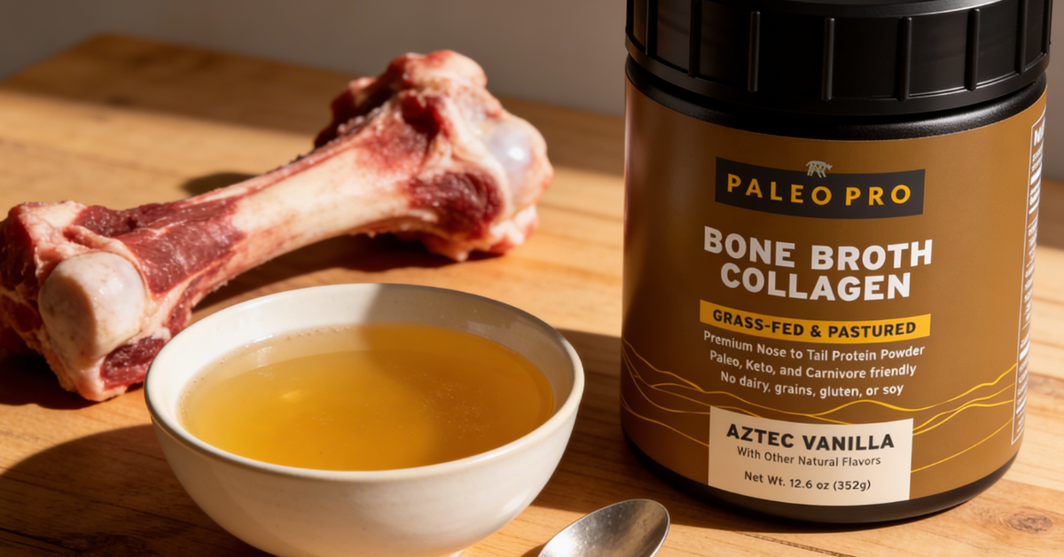 Bowl of golden bone broth with a spoon next to a bag of collagen powder and raw beef bones on a wooden surface
