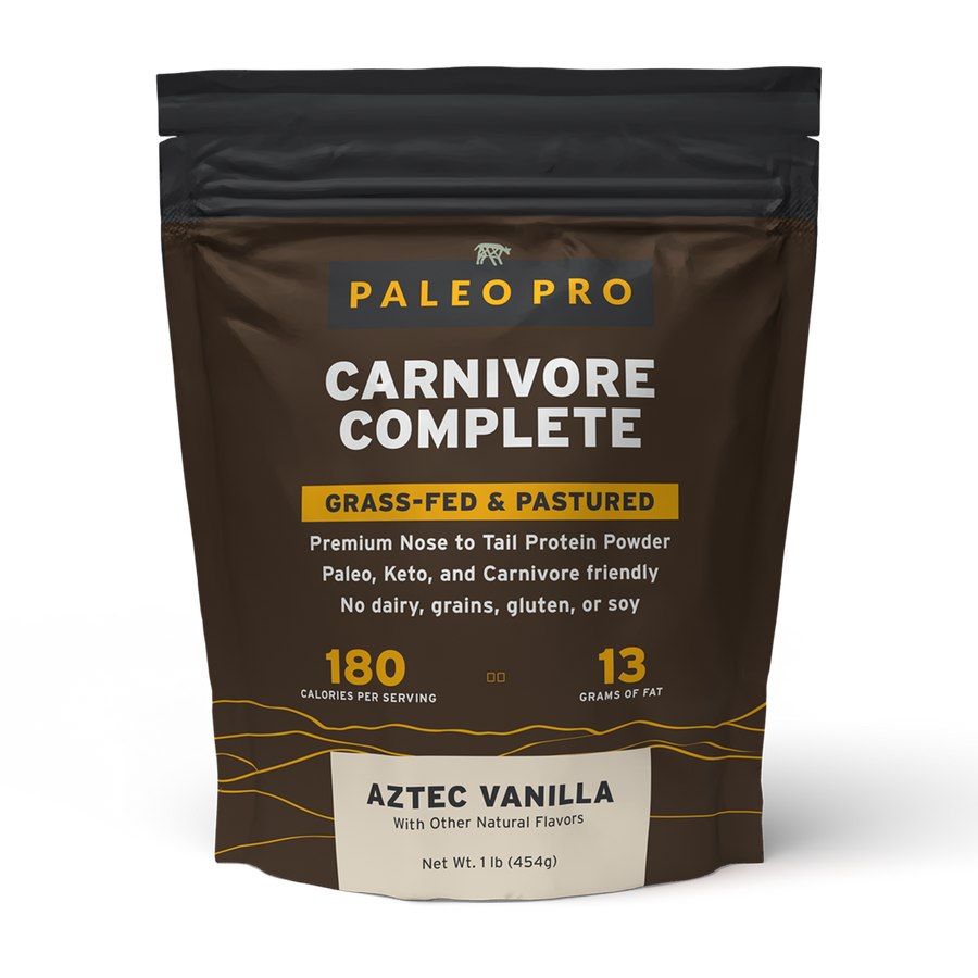 Grocery bag filled with raw steaks, eggs, bacon, butter, and salt on a kitchen counter