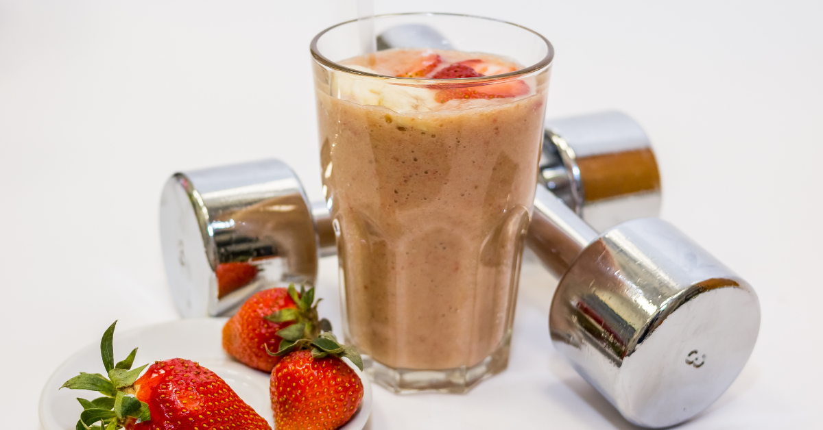 Dairy-free protein smoothie in a glass garnished with fresh fruit