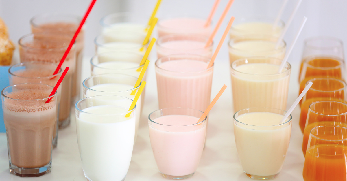 Multiple protein shakes lined up in a row showing a daily protein intake plan