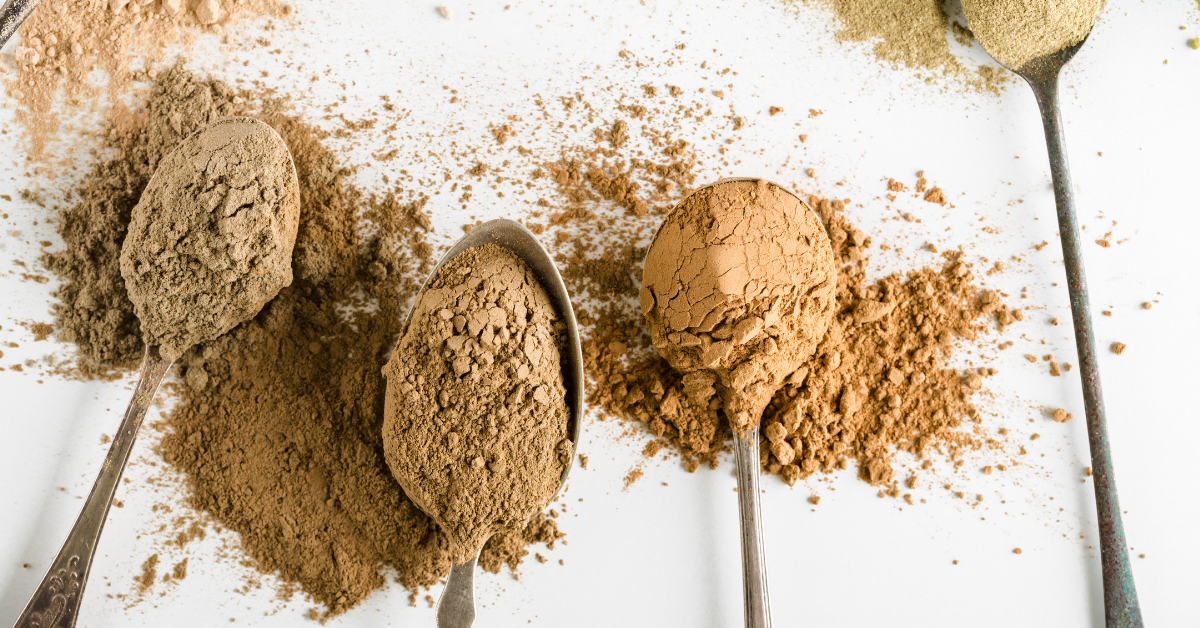 Three protein powder scoops side by side comparing whey, plant, and beef protein isolate