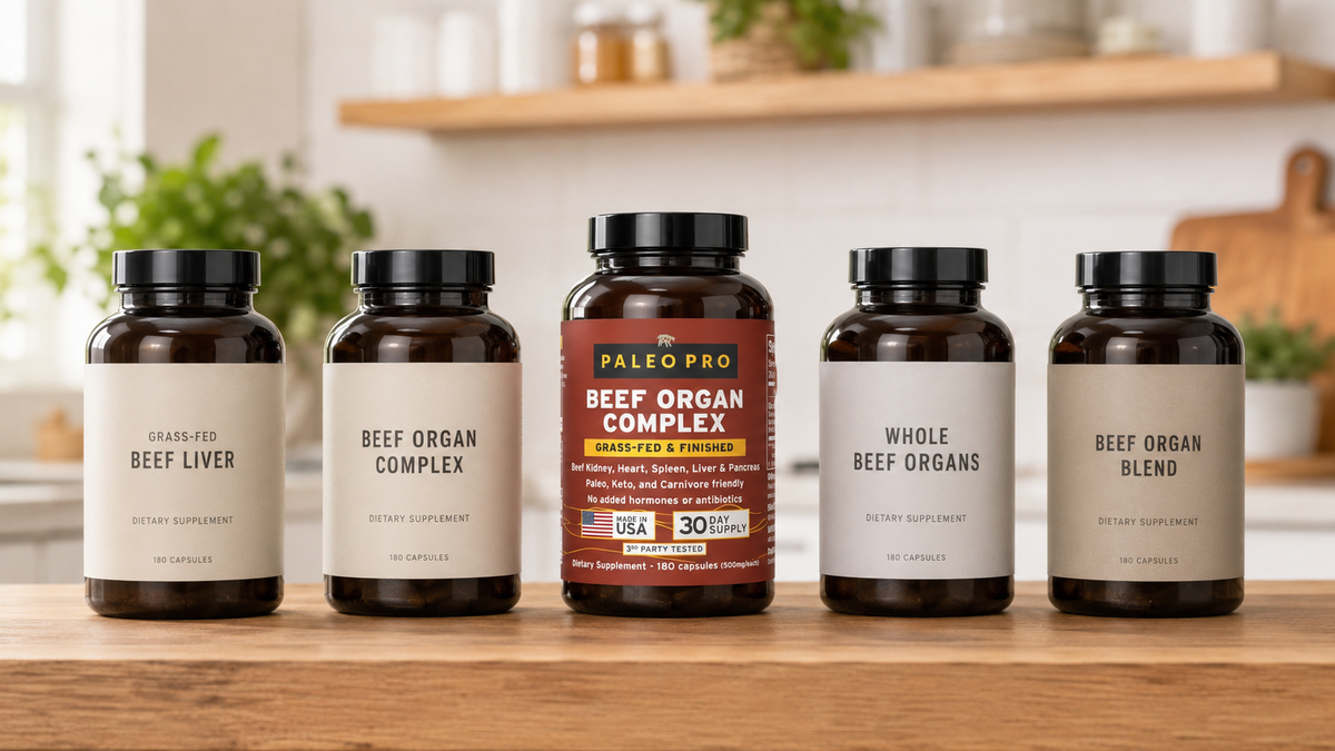 Several grass-fed beef organ supplement bottles lined up on a wooden shelf for comparison