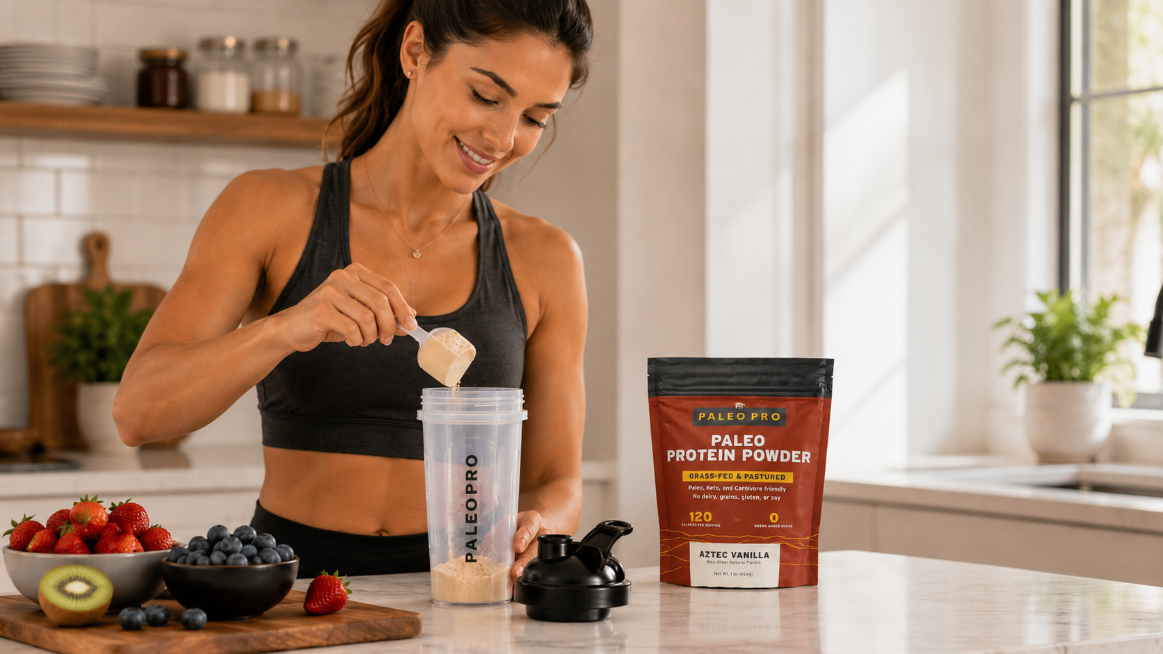 Woman scooping protein powder into a blender bottle on a kitchen counter with fresh fruit nearby